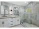 Elegant bathroom with marble walls, dual sinks, and a glass shower at 7390 E Hanover Way, Scottsdale, AZ 85255