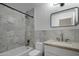 Bright bathroom features a marble tiled shower/tub and a vanity with modern fixtures and a rectangle mirror at 7390 E Hanover Way, Scottsdale, AZ 85255