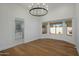 Bright dining room with hardwood floors, a chandelier, and an adjacent bathroom at 7390 E Hanover Way, Scottsdale, AZ 85255