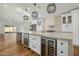 Open-concept kitchen featuring a large island, wine coolers, modern pendant lighting, and stainless steel appliances at 7390 E Hanover Way, Scottsdale, AZ 85255