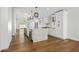 Open kitchen featuring a large island, wine coolers, modern pendant lighting, and hardwood floors at 7390 E Hanover Way, Scottsdale, AZ 85255