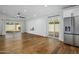 Bright living room with hardwood floors, stainless steel refrigerator, and access to the patio at 7390 E Hanover Way, Scottsdale, AZ 85255