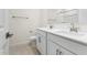 Double sink bathroom with white cabinets and brushed gold fixtures at 7511 S 75Th Dr, Laveen, AZ 85339