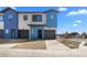 Two-story townhome with modern blue and white exterior, two-car garage, and desert landscaping at 7511 S 75Th Dr, Laveen, AZ 85339