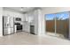 Modern kitchen with stainless steel appliances, white cabinets, and sliding glass door to patio at 7511 S 75Th Dr, Laveen, AZ 85339