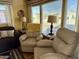 Living room with two beige recliners and large windows at 7750 E Broadway Rd # 860, Mesa, AZ 85208