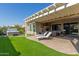 Spacious backyard patio with pergola, hot tub, and seating area at 7815 W Cinder Brook Way, Florence, AZ 85132