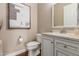 Powder room with vanity, toilet, and framed art at 7815 W Cinder Brook Way, Florence, AZ 85132