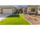 Single-story home with a two-car garage and landscaped front yard at 7815 W Cinder Brook Way, Florence, AZ 85132