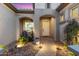 Inviting front entrance with a stone pathway, cozy seating, landscape lighting, and desert foliage at 7815 W Cinder Brook Way, Florence, AZ 85132