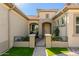 Inviting front entry with a metal gate and landscaping at 7815 W Cinder Brook Way, Florence, AZ 85132