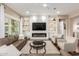 Modern living room with a built-in entertainment center and fireplace at 7815 W Cinder Brook Way, Florence, AZ 85132