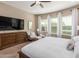 Main bedroom with large TV, seating area, and ample natural light at 7815 W Cinder Brook Way, Florence, AZ 85132