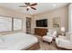 Spacious main bedroom with seating area and large windows at 7815 W Cinder Brook Way, Florence, AZ 85132