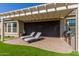 Covered patio with built in outdoor kitchen and lounge chairs at 7815 W Cinder Brook Way, Florence, AZ 85132