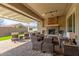 Covered patio with wicker furniture and fireplace at 7815 W Cinder Brook Way, Florence, AZ 85132