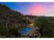 Luxury home and pool at sunset with mountain views at 8150 N 47Th St, Paradise Valley, AZ 85253