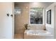 Spa-like bathroom with soaking tub and natural light at 8150 N 47Th St, Paradise Valley, AZ 85253