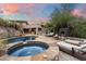 Luxury hot tub with outdoor fireplace and seating area at 8150 N 47Th St, Paradise Valley, AZ 85253