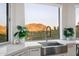 Farmhouse sink with mountain views from large windows at 8150 N 47Th St, Paradise Valley, AZ 85253