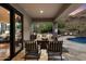 Covered patio with seating area, adjacent to the pool and offering mountain views at 8150 N 47Th St, Paradise Valley, AZ 85253