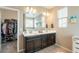 Bathroom with dual sink vanity, large mirror, and walk-in closet at 8535 E Olla Ave, Mesa, AZ 85212