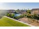 View of a playground and community pool surrounded by lush landscaping near residential houses at 8535 E Olla Ave, Mesa, AZ 85212