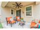 Cozy covered patio with two cushioned chairs, a small table and ceiling fan at 8535 E Olla Ave, Mesa, AZ 85212