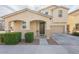 Inviting two-story home with neutral tones, landscaped front, covered entry, and attached two car garage at 8535 E Olla Ave, Mesa, AZ 85212