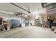 Well-organized garage with overhead storage racks, shelving, and utility sink at 8535 E Olla Ave, Mesa, AZ 85212