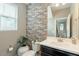 Stylish powder room features shiplap wall and a modern vanity with black countertop at 8535 E Olla Ave, Mesa, AZ 85212