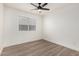 Simple bedroom with wood-look floors and ceiling fan at 8732 W Granada Rd, Phoenix, AZ 85037