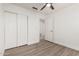 Well-lit bedroom with wood-look floors and ceiling fan at 8732 W Granada Rd, Phoenix, AZ 85037