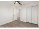 Bright bedroom with wood-look floors and double door closet at 8732 W Granada Rd, Phoenix, AZ 85037