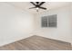 Charming bedroom with wood-look floors and a window with blinds at 8732 W Granada Rd, Phoenix, AZ 85037