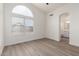 Spacious bedroom featuring wood-look floors and access to a bathroom at 8732 W Granada Rd, Phoenix, AZ 85037