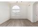 Bright bedroom with wood-look floors and an arched window at 8732 W Granada Rd, Phoenix, AZ 85037