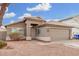 Single-story house with a tan garage door and desert landscaping at 8732 W Granada Rd, Phoenix, AZ 85037