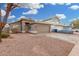 House exterior with a two-car garage and gravel landscaping at 8732 W Granada Rd, Phoenix, AZ 85037