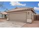 Front view of a single-story home with a large garage door at 8732 W Granada Rd, Phoenix, AZ 85037