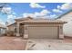 Front view of a single-story house with a tan garage door at 8732 W Granada Rd, Phoenix, AZ 85037