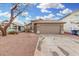 Single-story home with a brown garage door and a gravel driveway at 8732 W Granada Rd, Phoenix, AZ 85037