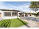 Home exterior with putting green and patio at 10377 W White Mountain Rd, Sun City, AZ 85351