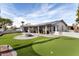 Home exterior with putting green and patio at 10377 W White Mountain Rd, Sun City, AZ 85351