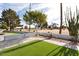 Landscaped backyard with putting green at 10377 W White Mountain Rd, Sun City, AZ 85351