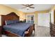 Bedroom with dark wood bed frame and pool view at 10377 W White Mountain Rd, Sun City, AZ 85351