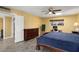 Bedroom with dark wood furniture and access to bath at 10377 W White Mountain Rd, Sun City, AZ 85351