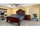 Bedroom with dark wood bed frame and built in desk at 10377 W White Mountain Rd, Sun City, AZ 85351