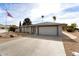 Single-story home with attached garage and desert landscaping at 10377 W White Mountain Rd, Sun City, AZ 85351