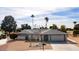 Single story home with grey roof and desert landscaping at 10377 W White Mountain Rd, Sun City, AZ 85351